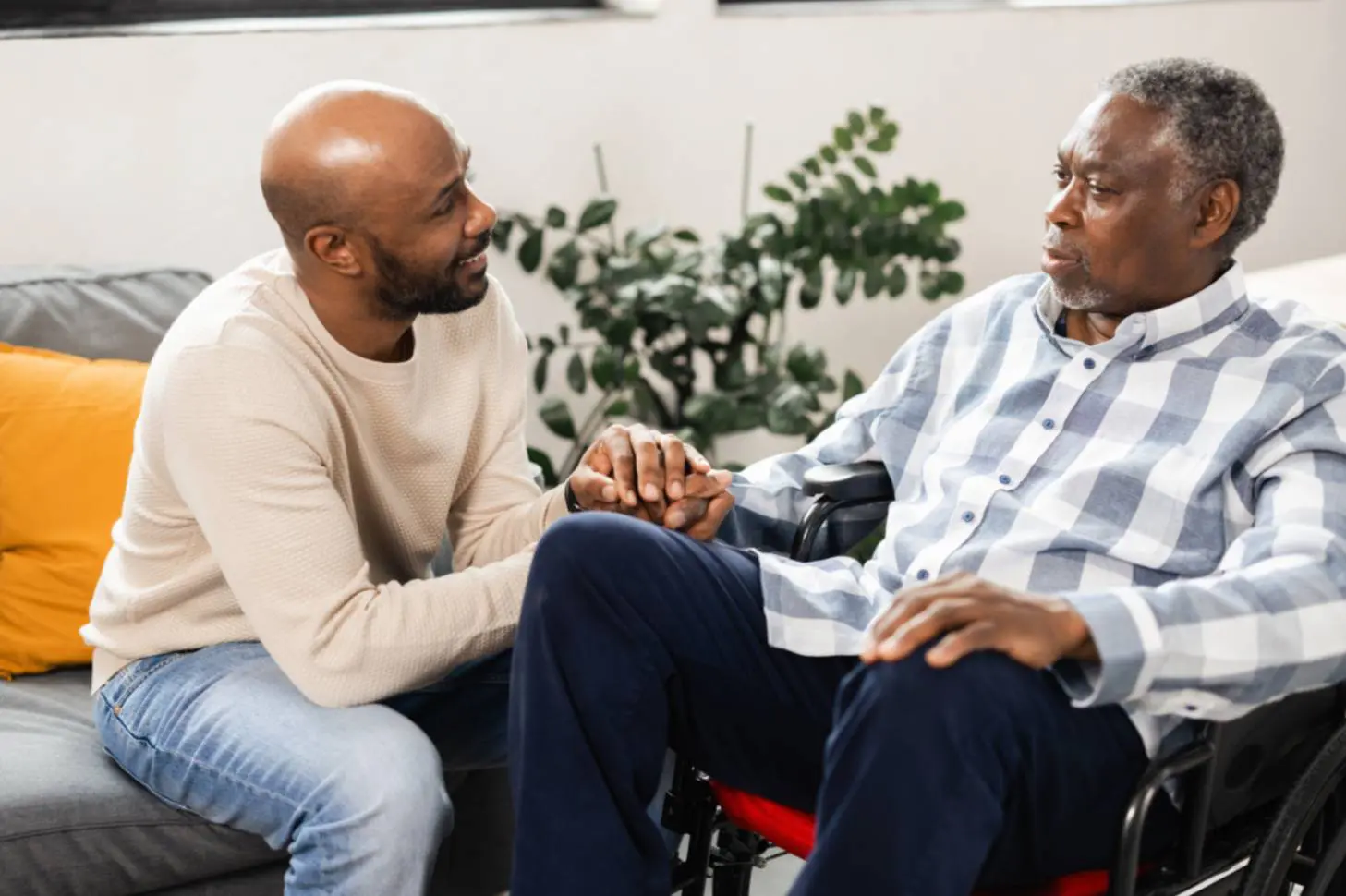 A man holding old man's hand